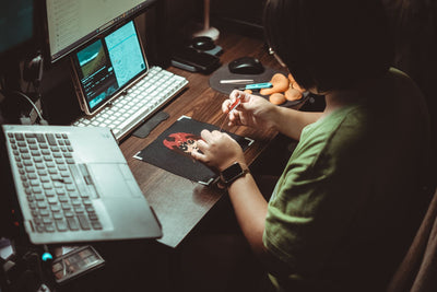 Person working on a digital embroidery design at a computer — I Can Help Sew Flowood class