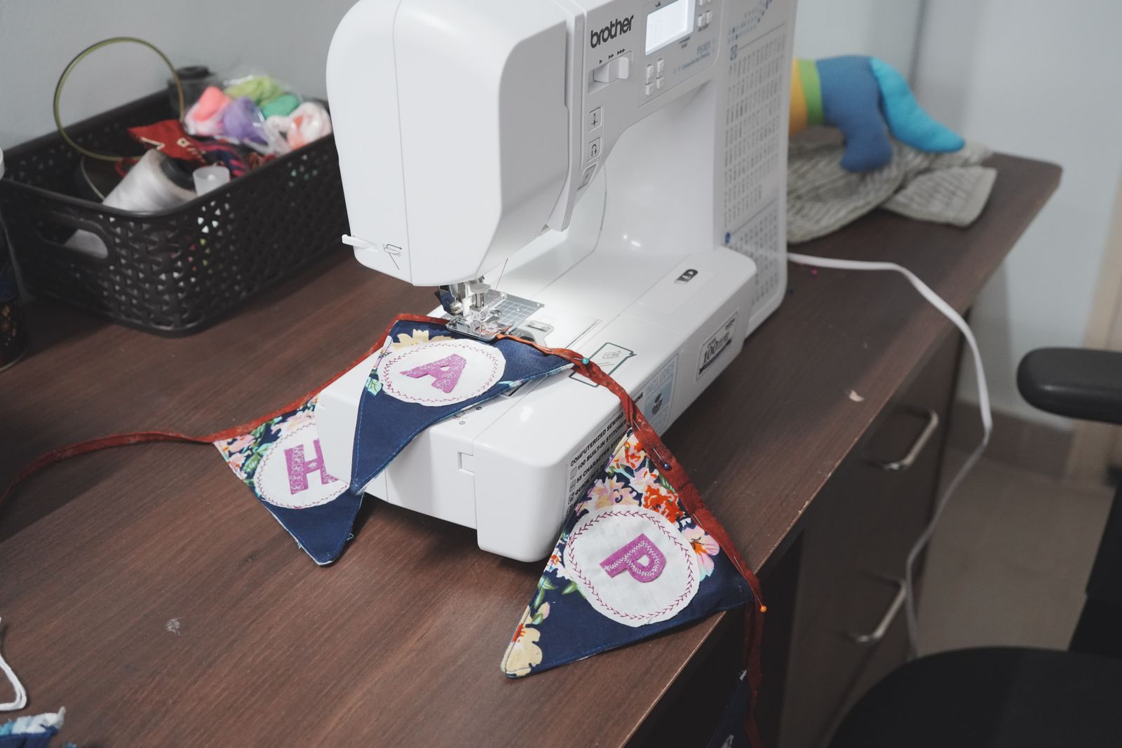 Sewing machine stitching colorful cut fabric appliqué shapes — I Can Help Sew Flowood class